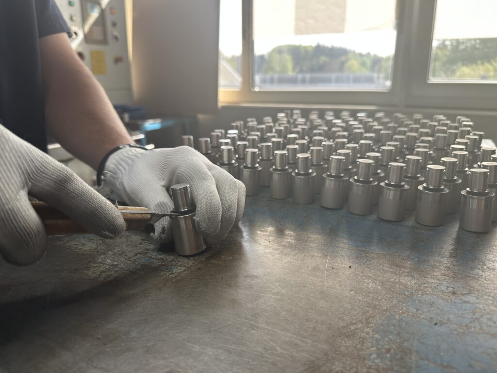 Manual deflashing of rubber molded and composite parts.